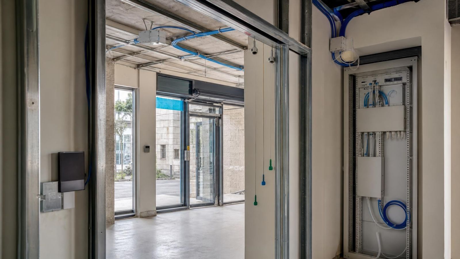 מתקין בוחן תכנית חיווט למצלמות, אזעקה ואינטרקום באתר בשיפוץ